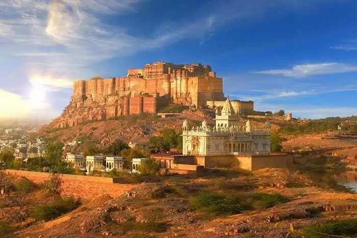  A majestic view of Mehrangarh Fort against a blue sky.